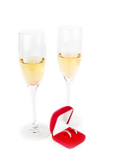 Two Valentine's champagne glasses with jewelery on white