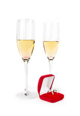 Two Valentine's champagne glasses with jewelery on white