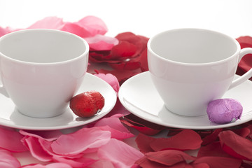 Coffee cup and rose petals 