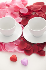 Coffee cup and rose petals 