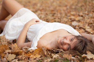  woman lies in oak leaves
