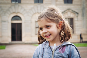 Naklejka na ściany i meble Smiling young girl close up portrait outdoors.