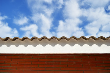 The top of the roof against the blue sky