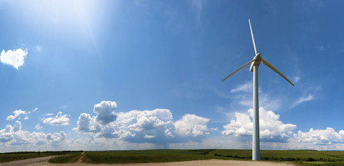 Stock Photo of windmill in blue sky with clouds