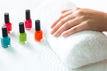 Woman in nail salon receiving manicure