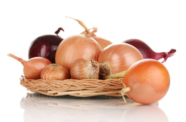 Ripe onions on wicker cradle isolated on white