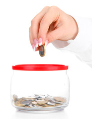 Woman hands with coins in glass jar isolated on white