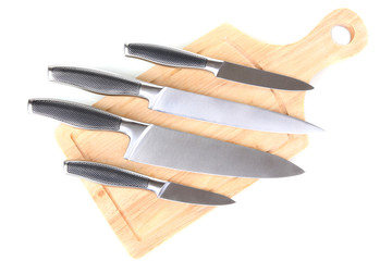 Set of knives on cutting board isolated on white