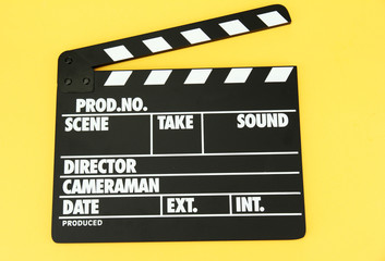 Fototapeta na wymiar Movie production clapper board on color background