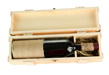 Wine bottle in wooden box, isolated on white