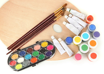 Wooden art palette with brushes for painting and paints