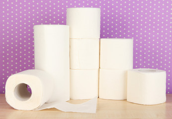 Rolls of toilet paper on purple with dots background