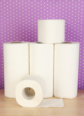 Rolls of toilet paper on purple with dots background