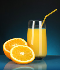 Delicious orange juice in glass and oranges next to it