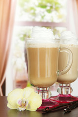 Fragrant coffee latte in glasses cups with vanilla pods,