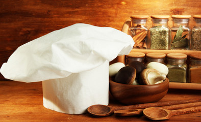 Composition with chef's hat on wooden background