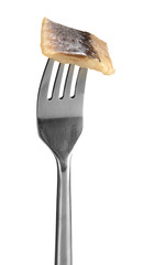 Piece of herring on fork isolated on white