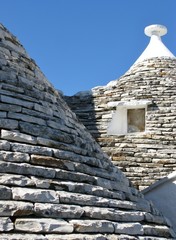 Fototapeta na wymiar The roofs of trulli houses in Alberello in Italy