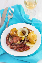 octopus with potato and oil on the plate