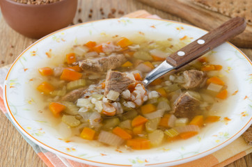 soup with beef and buckwheat groats in a plate closeup