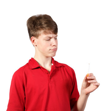 teen boy looks at a cigarette