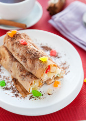 pancakes with a fruit stuffing and grated chocolate