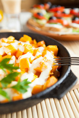 pumpkin baked in sour cream in a pan