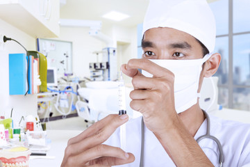 Doctor giving injection at hospital