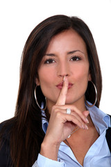 Businesswoman gesturing for silence