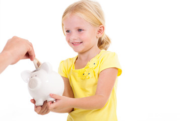 cute little girl with piggybank receiving money