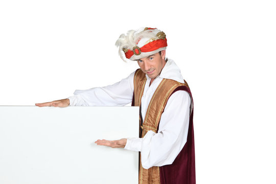 Man In Sultan Fancy Dress Costume With Blank Board