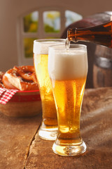 Pouring glasses of frothy beer