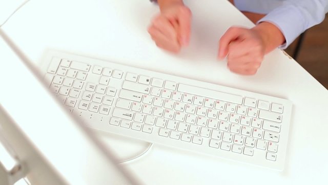 young woman gets angry and breaks the keyboard
