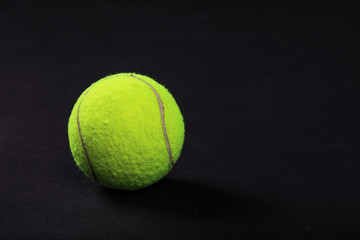 tennis balls on black background studio shot