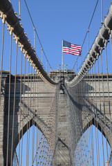 American flag on top of famous Brooklyn Bridge