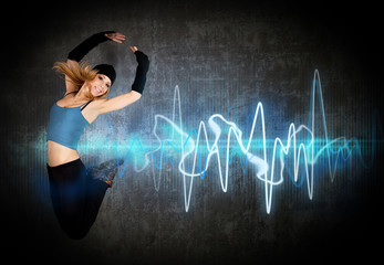 Woman jumping/dancing to the music rhythm