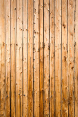 Weathered yellow fence from natural wood, portrait