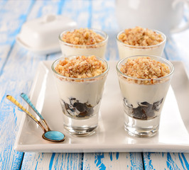 Dessert of prune and sour cream in a small glass