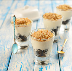 Dessert of prune and sour cream in a small glass