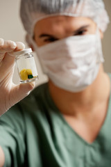 Surgeon Holding Pill Bottle