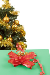 yellow decorated christmas tree  and gift with red ribbon