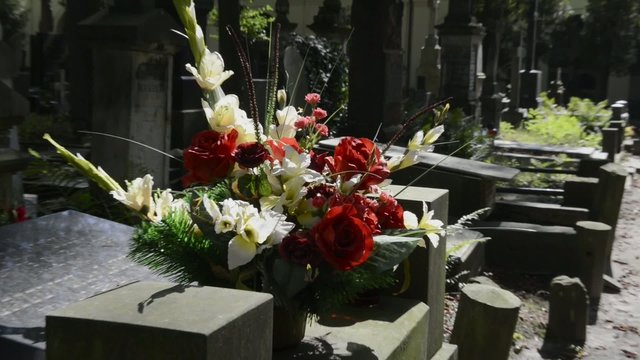Fresh flowers on grave at historic Warsaw cemetery, Powazki