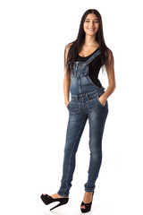 Happy young woman standing with hands in pockets