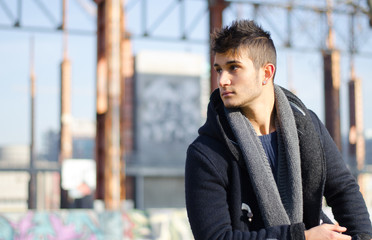 Handsome young man in urban setting, large copyspace