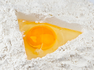 one raw egg into triangular hole flour