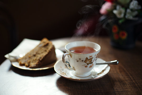 traditional tea and cake on wooden cafe table