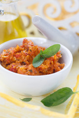 Red pesto in a white bowl