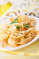 Pasta with red pesto sauce with fresh basil