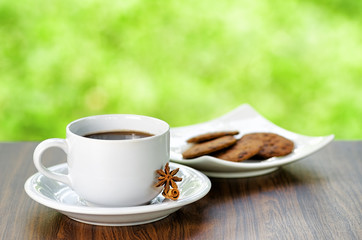 Coffee and oatmeal cookies on nature background