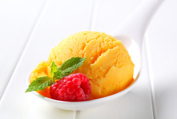 Yellow ice cream on spoon